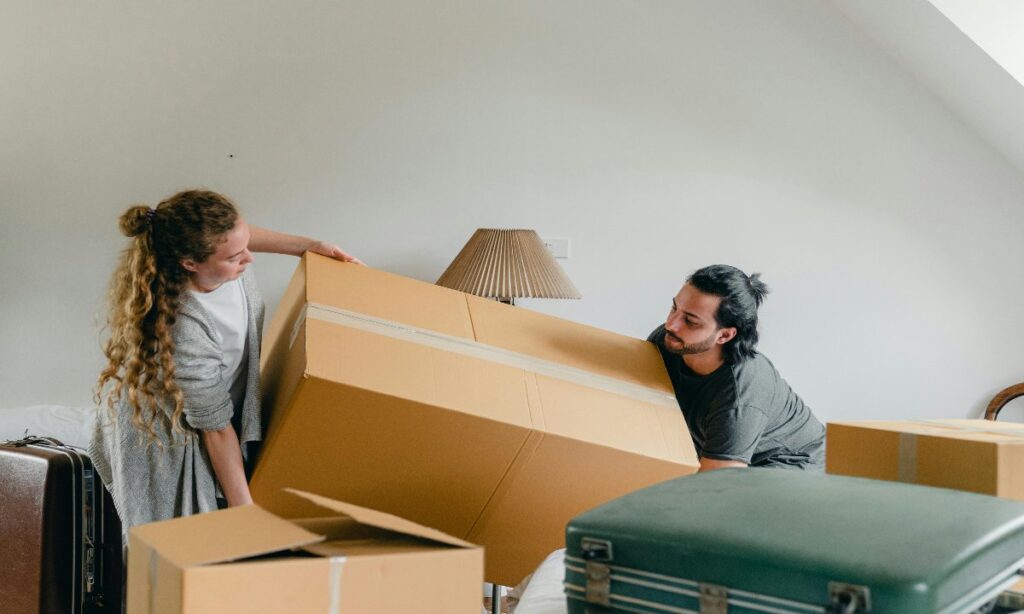 a man and woman holding a large box